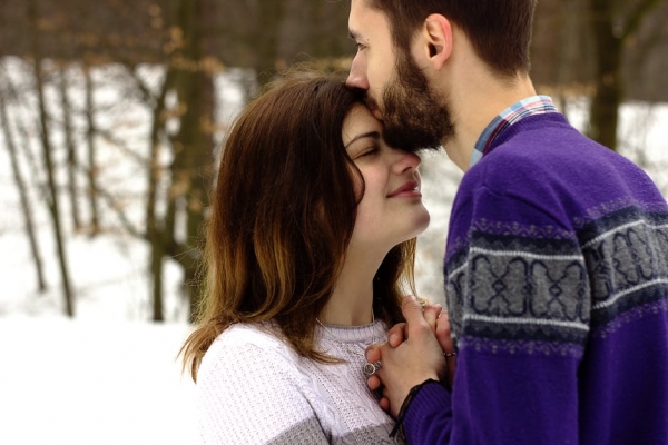 Man Kissing Woman's Forehead