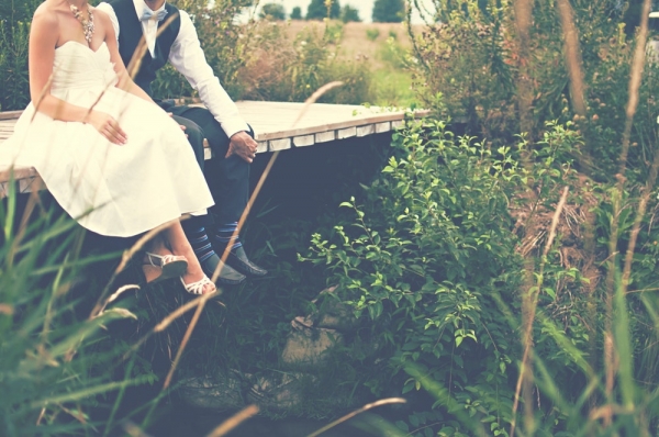 couple sitting on wooden pidge