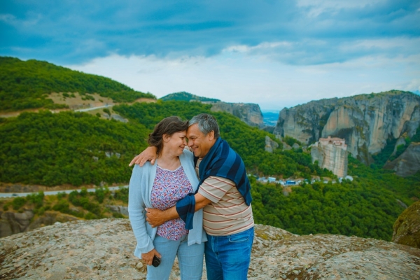 man empacing the woman on top of hill