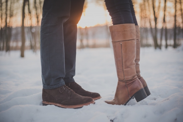 two person in pown boots and shoes on snowy forest