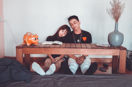 Sitting Woman and Man Wearing Black Crew-neck T-shirts