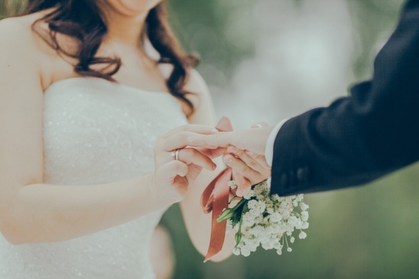 woman giving wedding ring to man